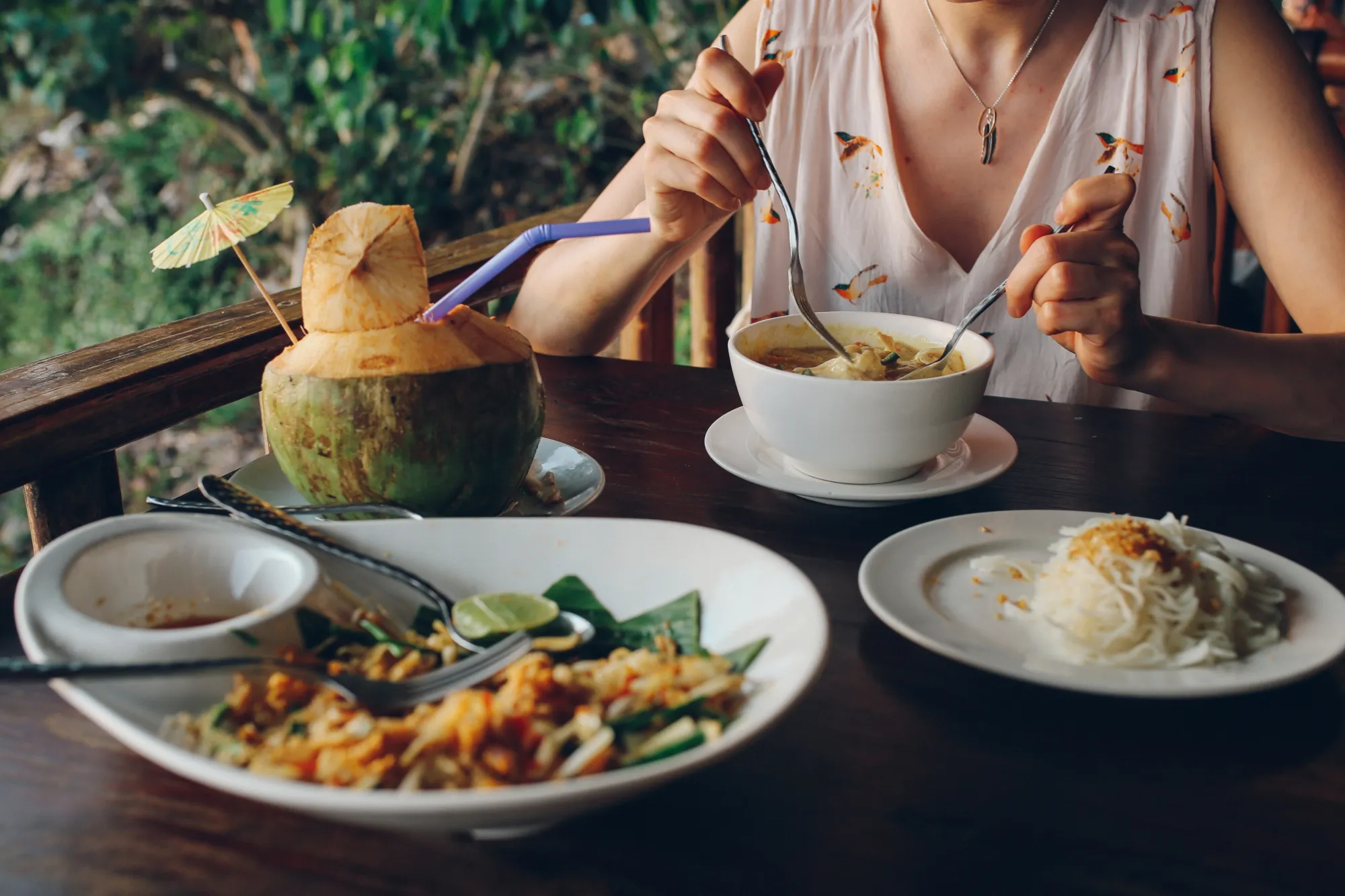 Image of a woman eating Thai food in Koh Lanta, Thailand