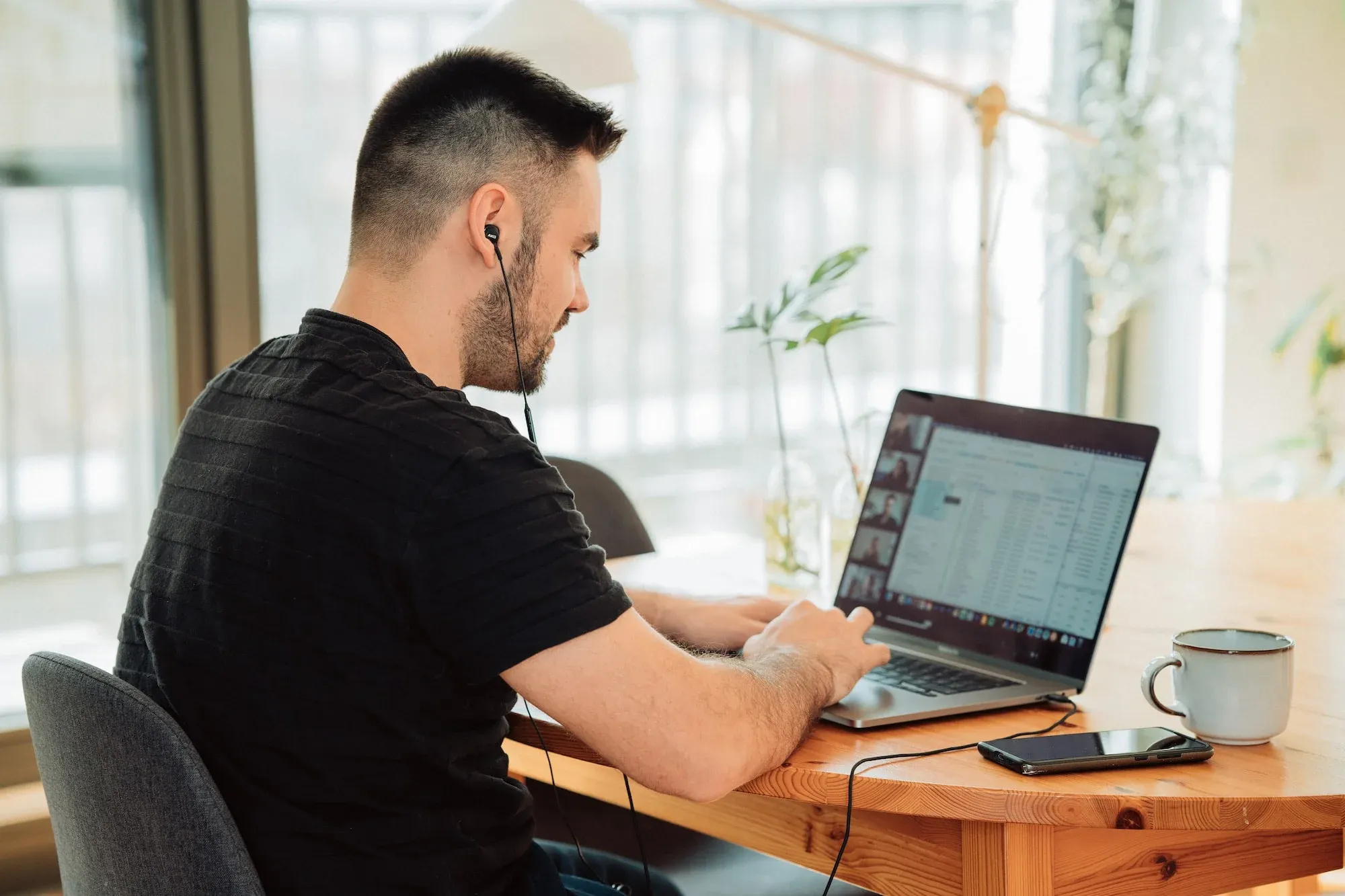 Image of a man working from his laptop