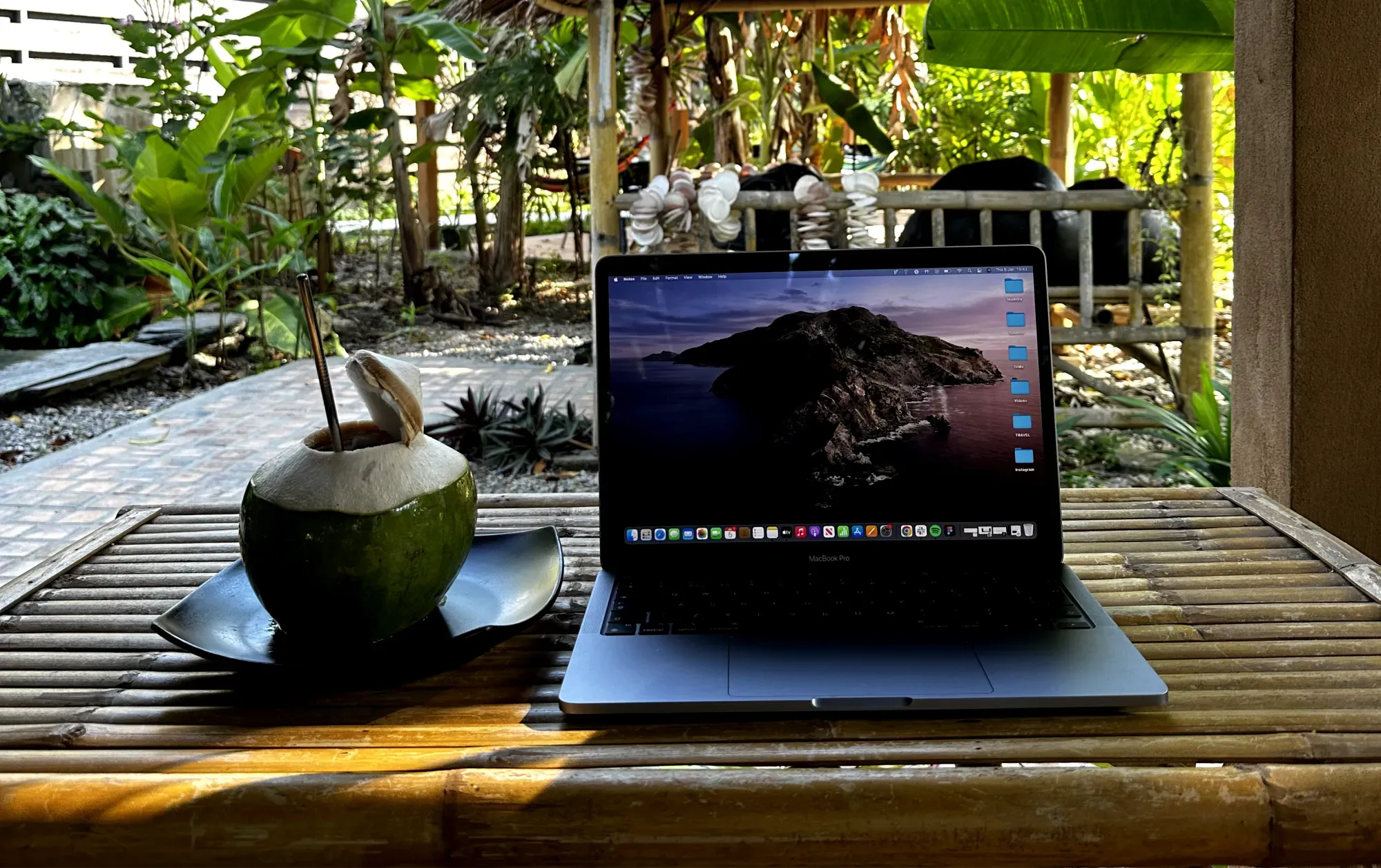 a laptop of a ux/ui designer in a tropical coworking