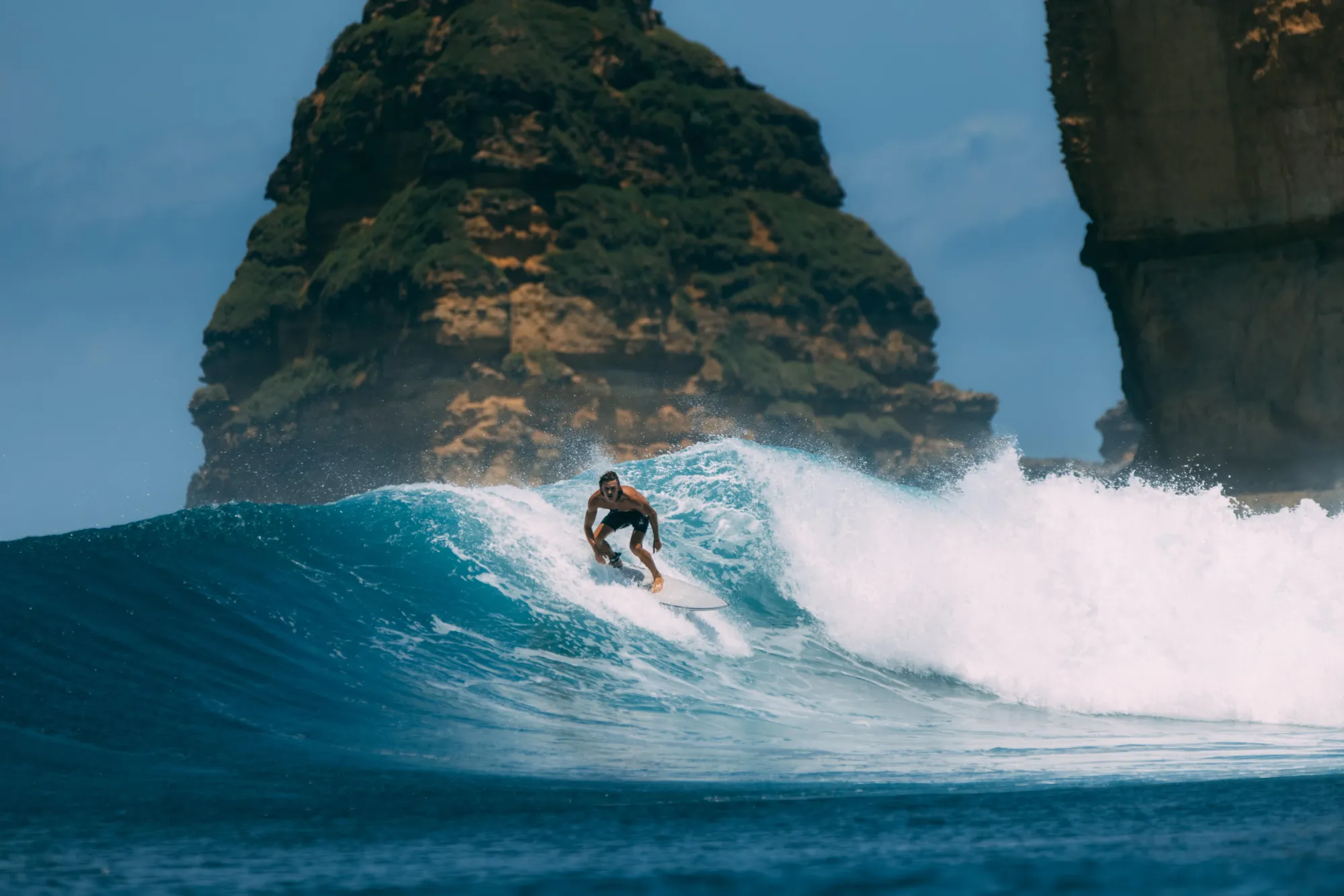 Surfer riding a wave in Indonesia