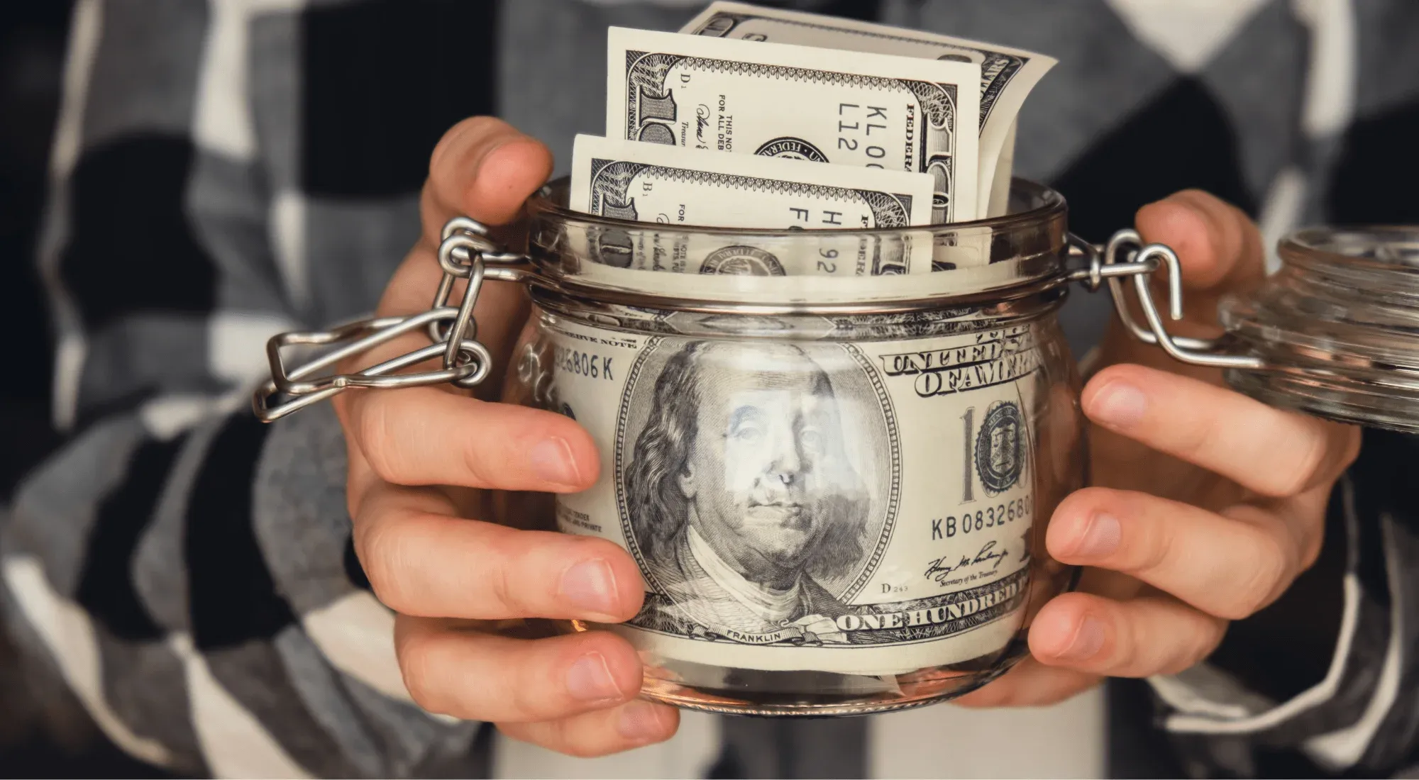 Digital nomad holding a jar of savings