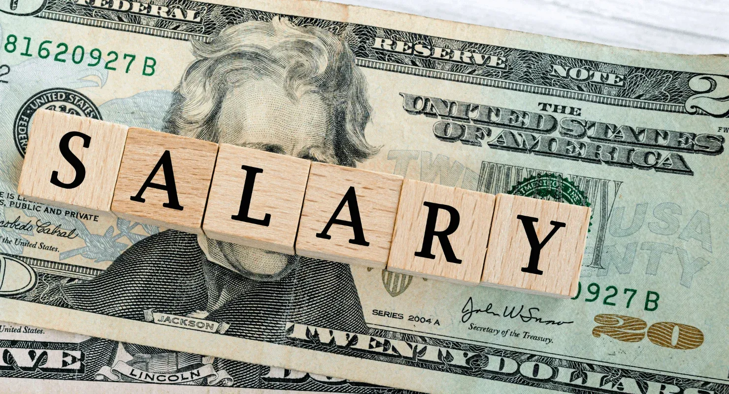 Salary sign on top of twenty US dollar bill