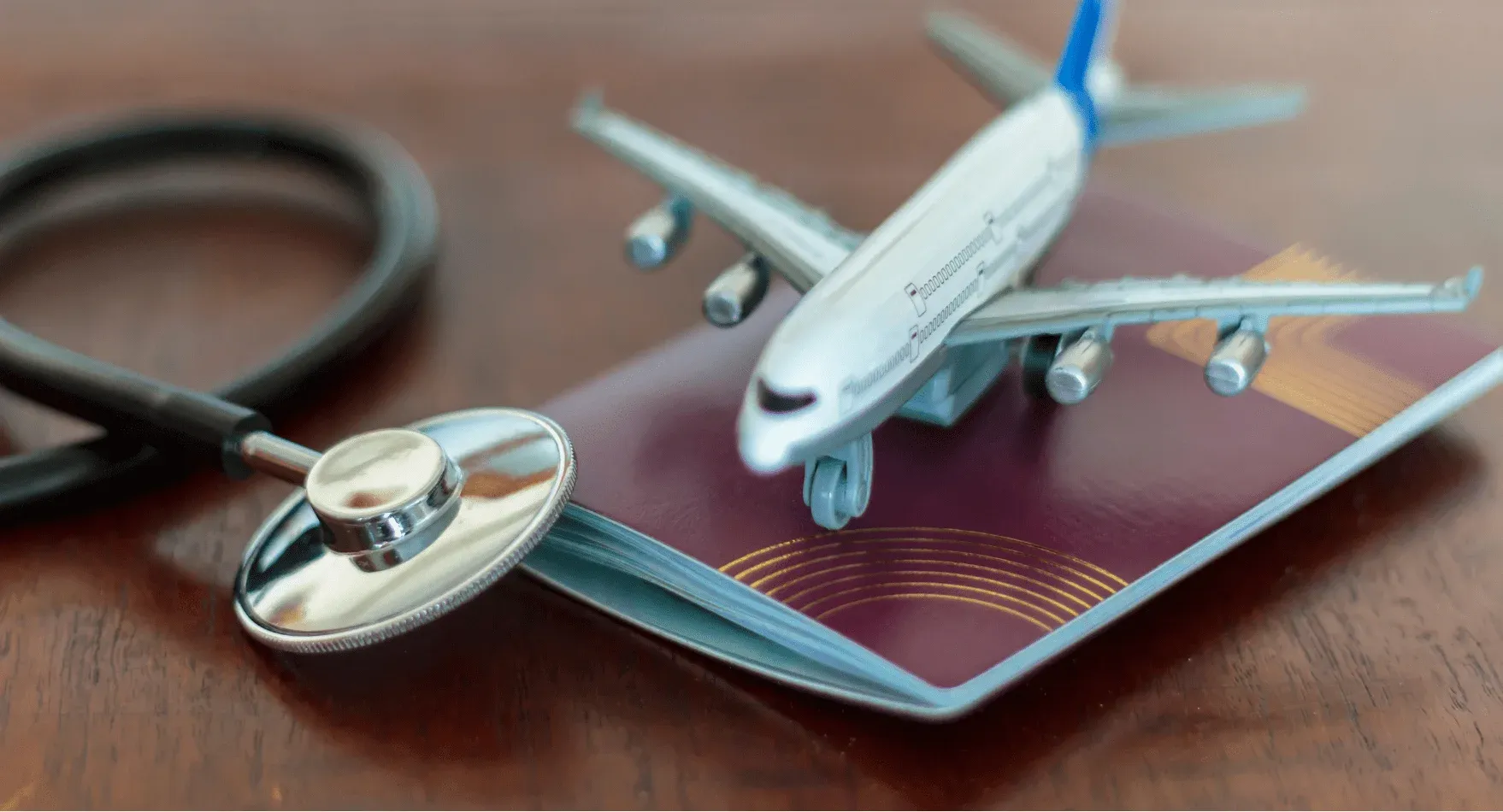 Passport, airplane model, and stethoscope