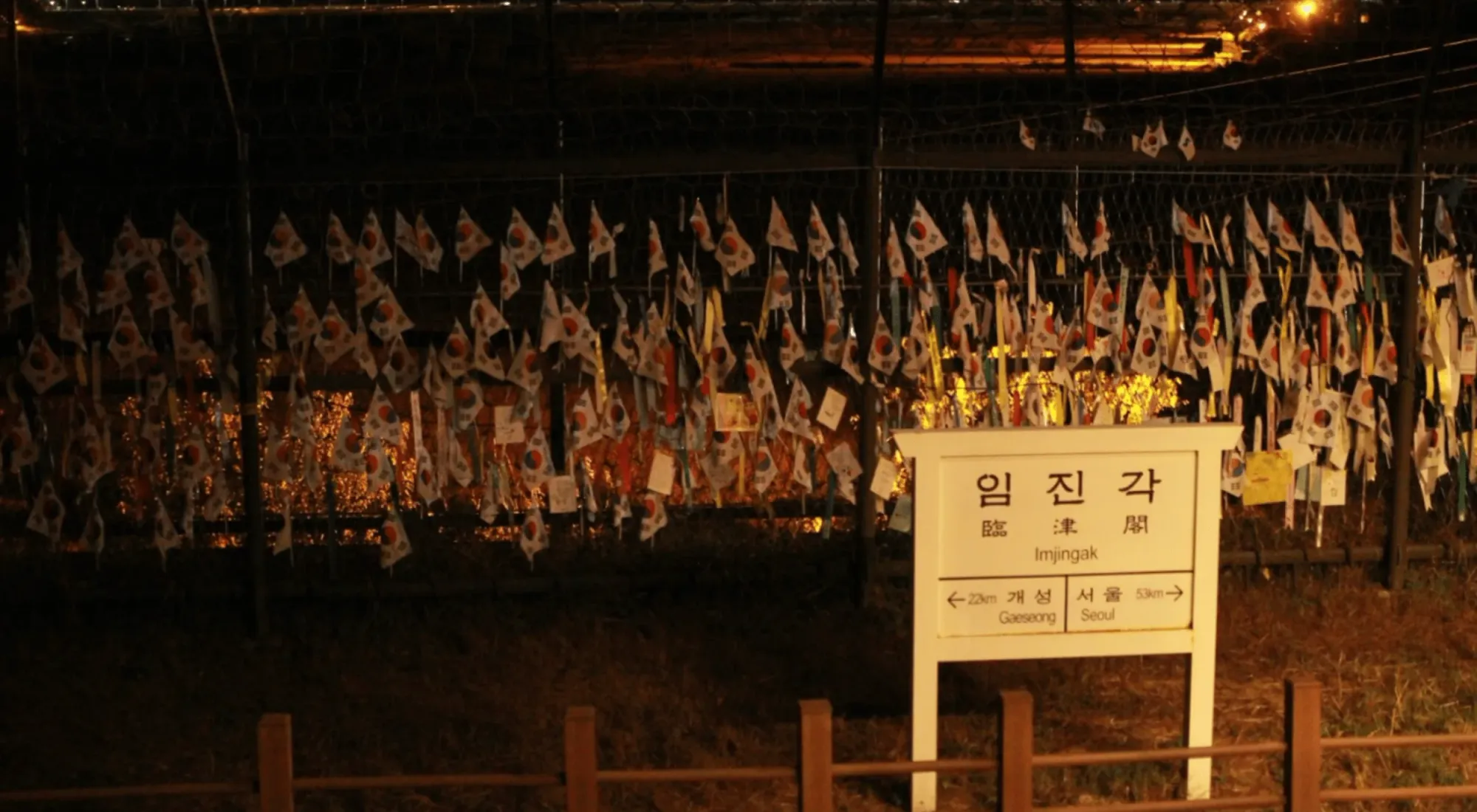 Commemorative Korean flags planted along the fence marking the DMZ