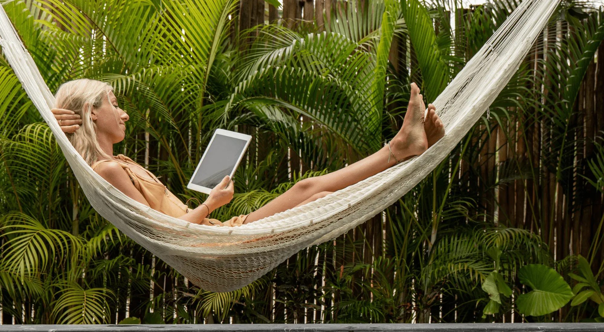 Digital nomad working from her hammock