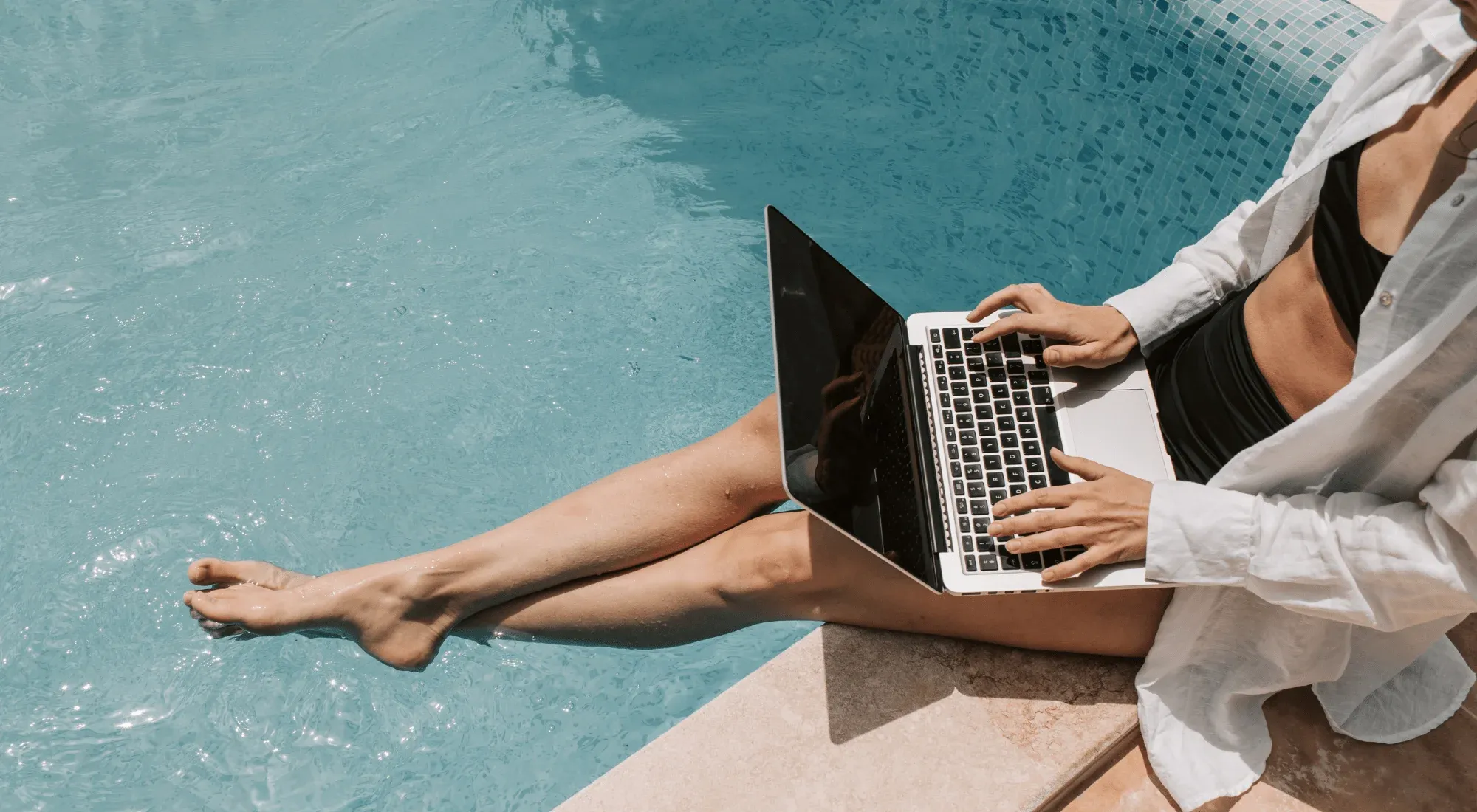 Digital nomad working from the pool