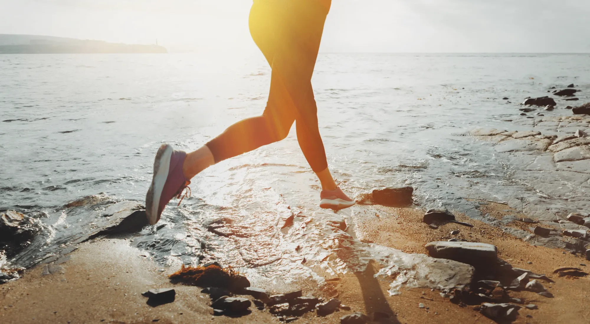 Person running in the morning at the beach