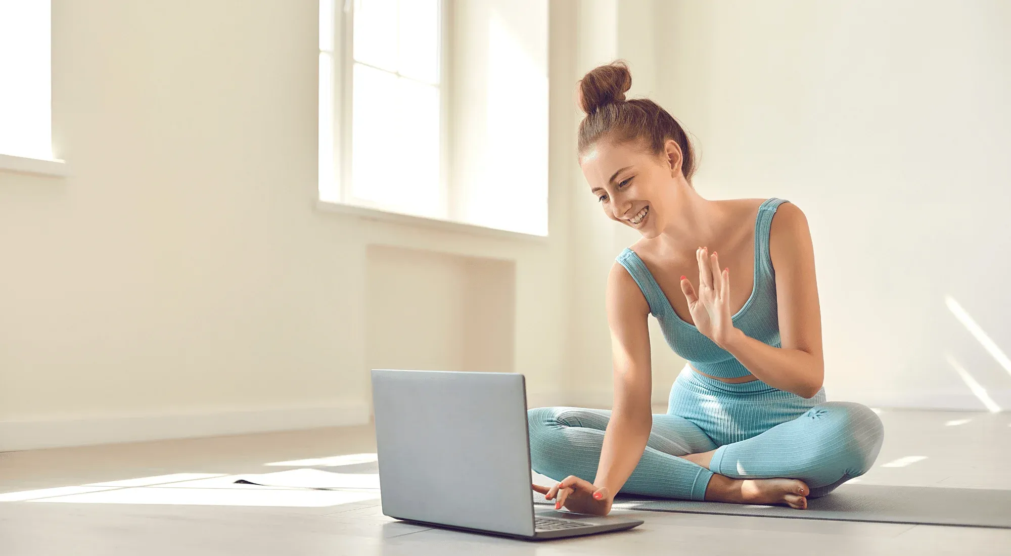 Yoga coach working remotely with her laptop