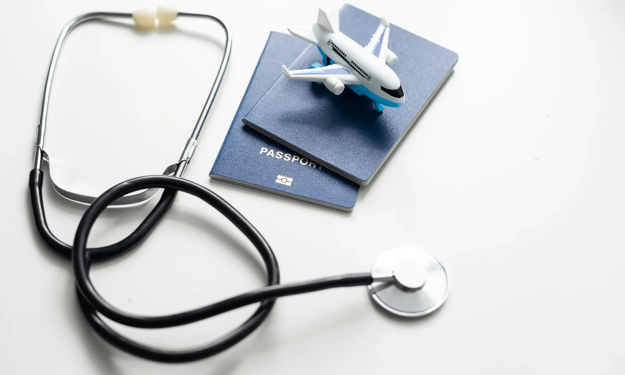 Airplane, passports, and stethoscope to symbolize medical tourism