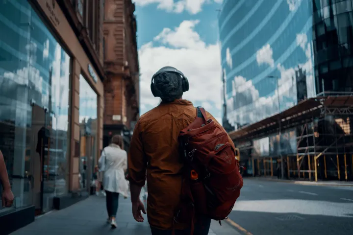 a remote worker walking around Glasgow with his headphones on