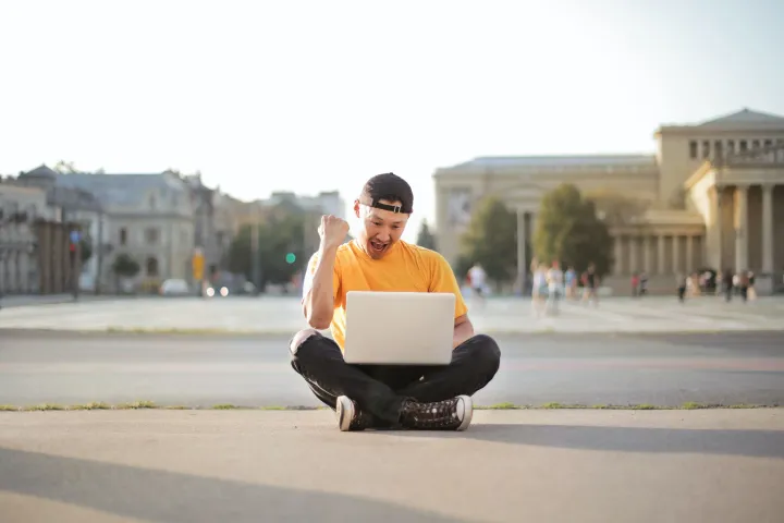 Happy digital nomad using 5G mobile wifi hotspot outdoor
