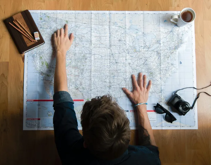Digital nomad over a paper map
