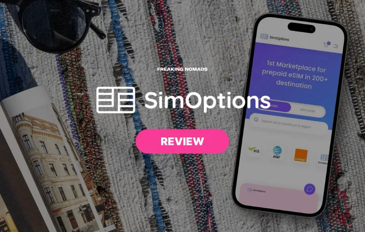 SimOptions eSIM website on a phone on a beach towel with SimOptions logo in the foreground