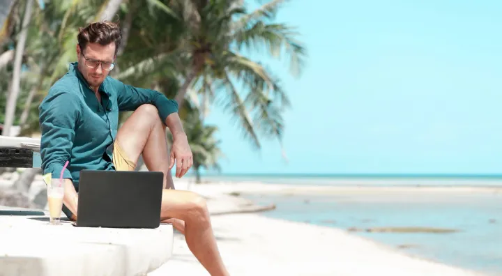 digital nomad working from a beach