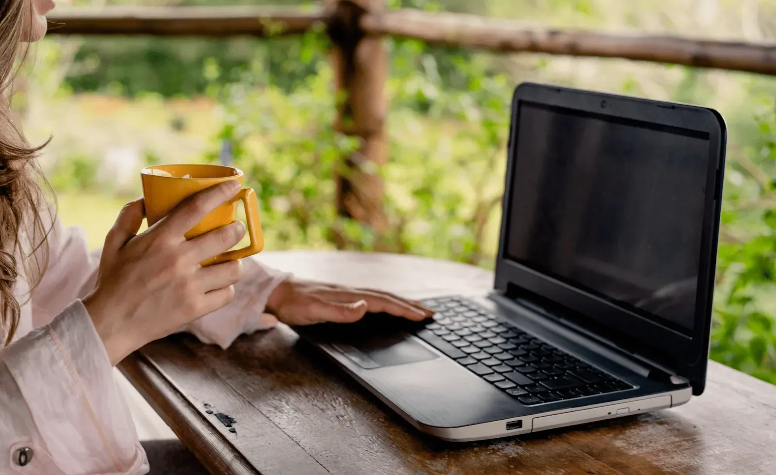 nomade digitale che beve un caffè mentre lavora dal suo portatile